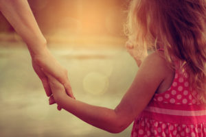 mother and daughter holding hands